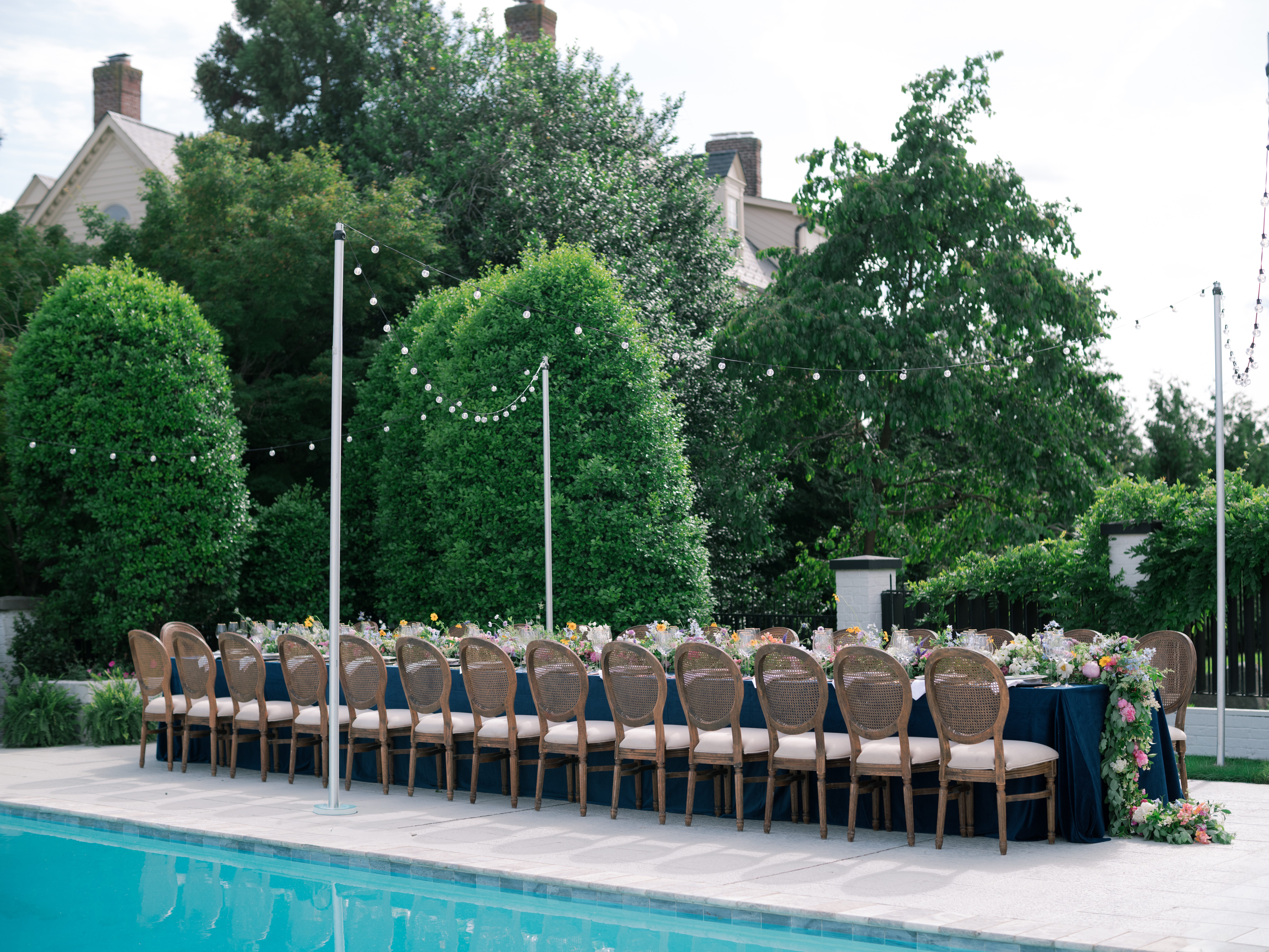 chic table near backyard pool for an intimate dinner party wedding